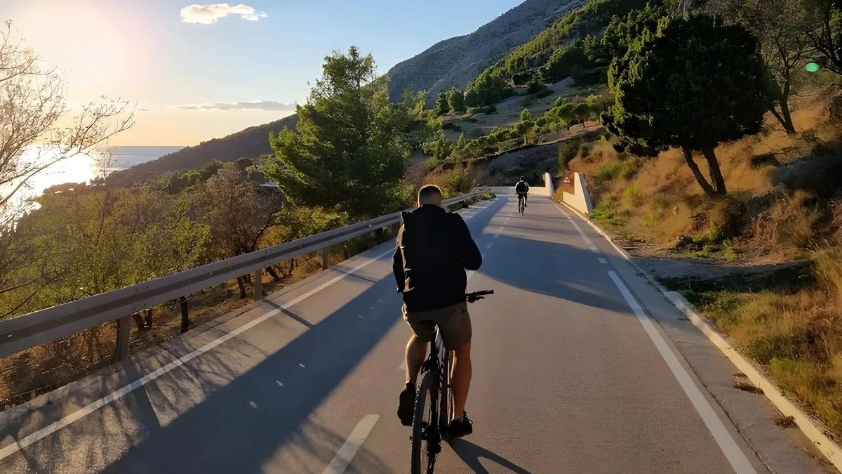 Cyclist exploring Bol on Brač Island, Croatia, riding coastal and mountain trails with panoramic views of Zlatni Rat Beach and the Adriatic Sea – Cycling Croatia Central Dalmatia