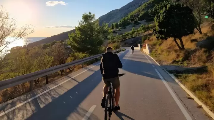 Cyclist exploring Bol on Brač Island, Croatia, riding coastal and mountain trails with panoramic views of Zlatni Rat Beach and the Adriatic Sea – Cycling Croatia Central Dalmatia