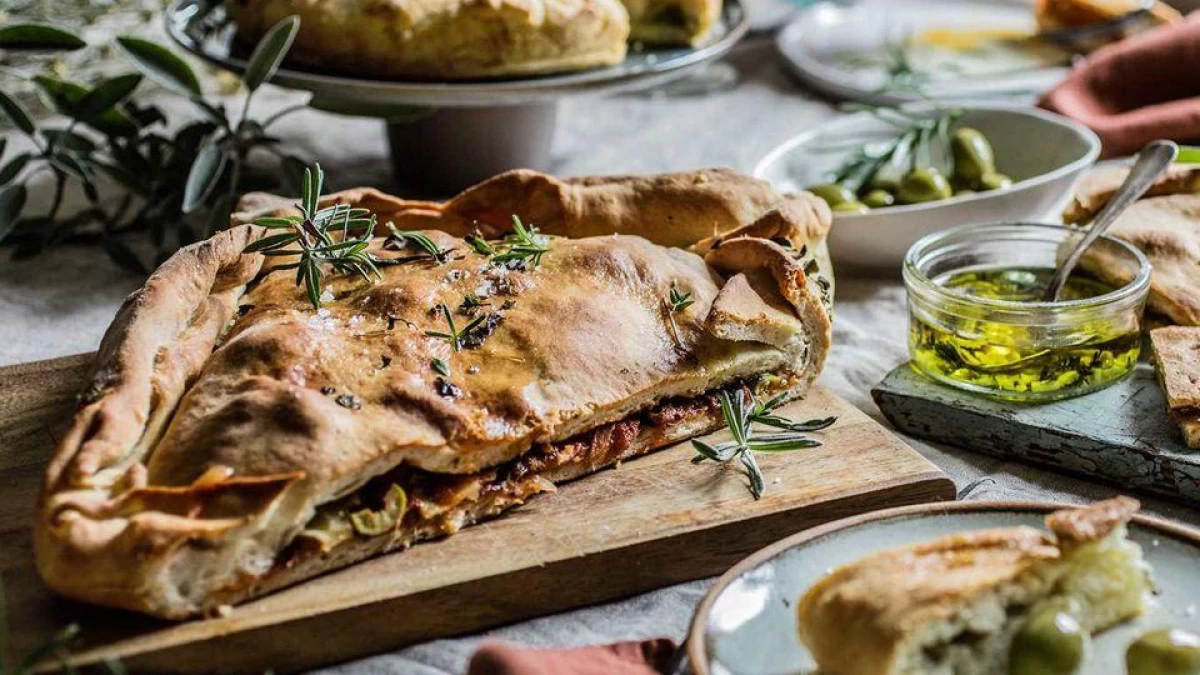 Traditional Croatian food Komiška pogača, savory baked pie from Vis Island filled with salted fish, onions, and Mediterranean flavors