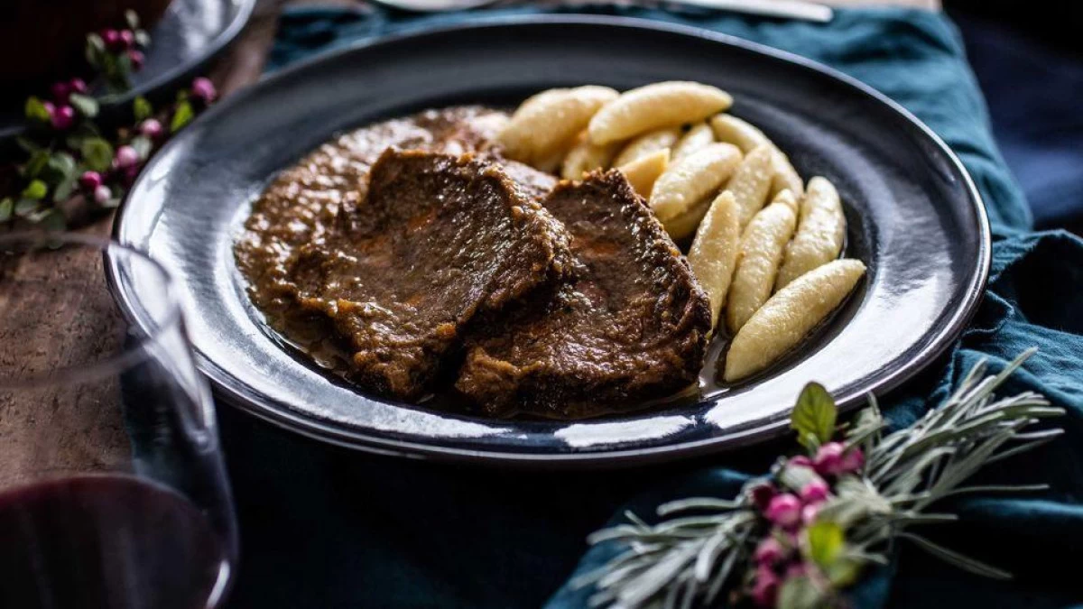 Traditional Croatian food pašticada, slow-cooked Dalmatian beef stew in rich red wine sauce, served with homemade gnocchi