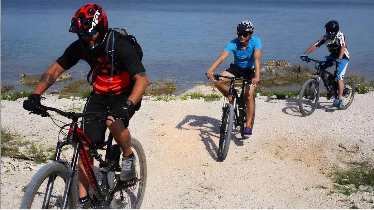 Cyclist riding along coastal roads in Primošten with sea views