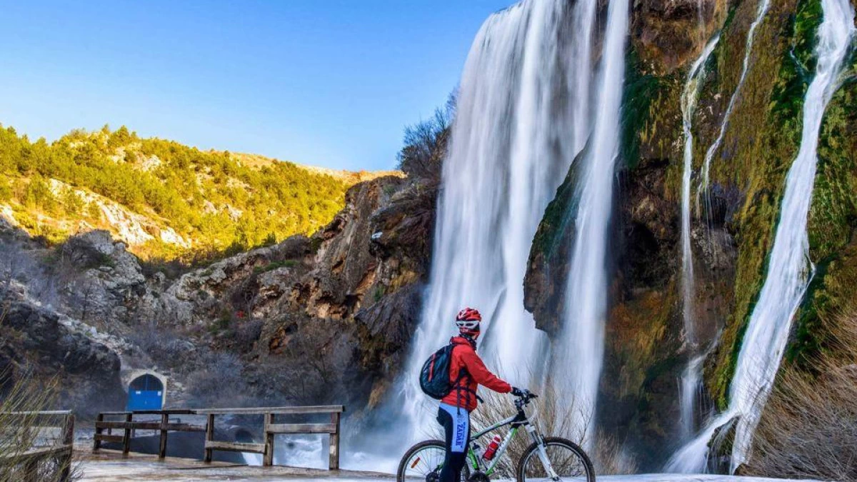 Cyclist exploring Krka National Park in Croatia, riding along trails next to the famous waterfalls surrounded by lush greenery – Cycling Croatia Šibenik region