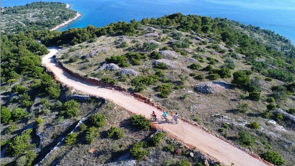 Cyclist riding along seaside trails on Murter Island near Šibenik, Croatia