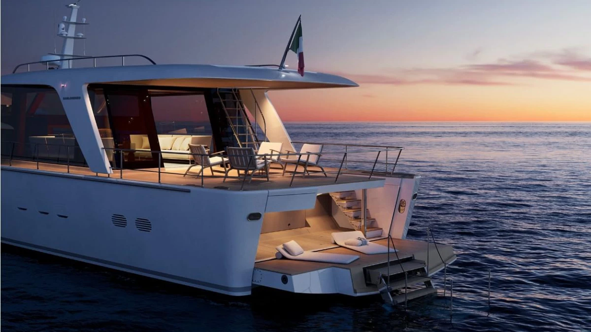 Front deck of Sanlorenzo SHE yacht featuring minimalist 1960s-inspired design and elegant sunbathing area with sea views.